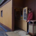 Rick Fleming opening entrance door to Sanford Lake Bar & Grill, Sanford, MI