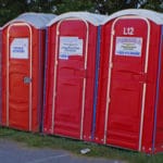 three red portable restrooms