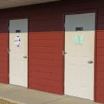 Entry doors to showers and restrooms for overnight lodging at Yellowstone Dog Sports, Roberts MT