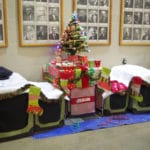 Christmas tree and gifts on dog crate at MSU Livestock Pavilion, Lansing MI
