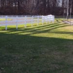 White fence and grass for dog potty area outside main door at MSU Livestock Pavilion, Lansing MI