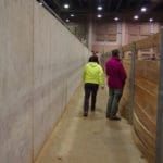 Cement on left, wood ring barrier on right in walkway to rings at MSU Livestock Pavilion, Lansing MI