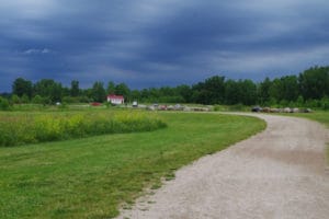 Dark threatening sky showing a bit of a hike to the parked cars at Prairie Oaks Metro Park, Hilliard OH