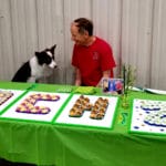 Jim Turner with border collie Mysti, MACH 20 cakelets with letters and number spelled out