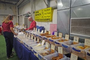 dog bones direct vendor with about 20 bins of dog treats