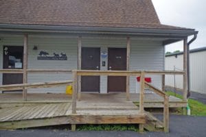 Front doors of restroom building with wooden access ramp at Bella Vista Training Center, Lewisberry PA