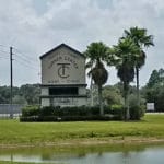 Outdoor sign by road surrounded by palm trees for Turner Agri-Civic Center, Arcadia FL