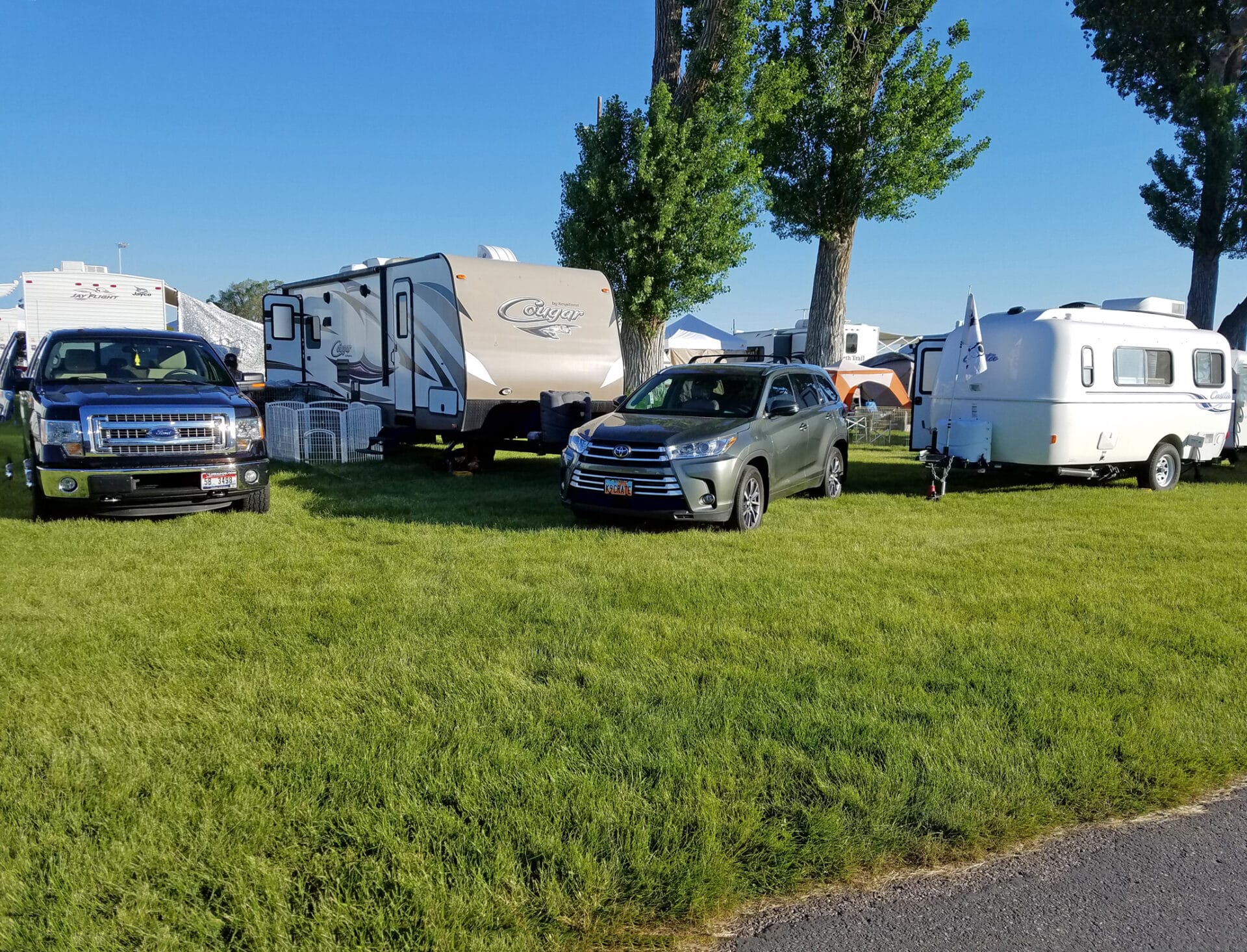 RVs and campers at easy up tents and dog crates along side of agility ring at East Idaho Fairgrounds-BlackfootID