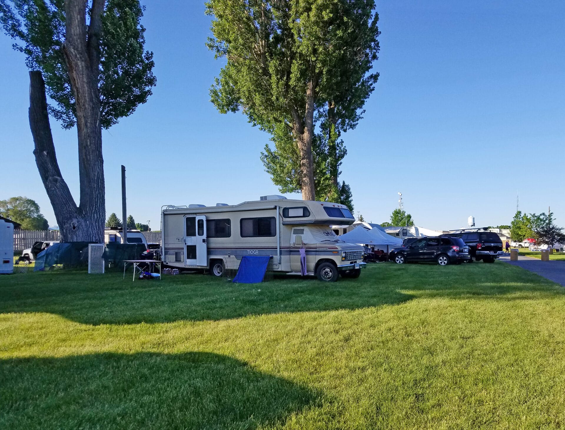 grass and RVs at easy up tents and dog crates along side of agility ring at East Idaho Fairgrounds-BlackfootID