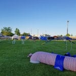 agility ring at easy up tents and dog crates along side of agility ring at East Idaho Fairgrounds-BlackfootID