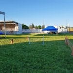 agility warm up jump with food truck in background easy up tents and dog crates along side of agility ring at East Idaho Fairgrounds-BlackfootID