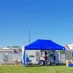 Food vendor truck and tent at easy up tents and dog crates along side of agility ring at East Idaho Fairgrounds-BlackfootID