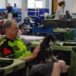 man sitting with miniature schnauzer on his lap at Ann Arbor Dog Training Club, Ann Arbor MI