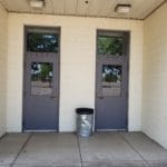 Two alternative entry doors with waste basket in between at Lane County Fairgrounds, Eugene OR