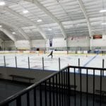 Person skating on large, well-lit Ice Rink, Nex Level Arena, Flemington NJ