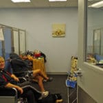 two women sitting in chairs by crates, relaxing, at Fusion Pet Retreat, Minnetonka MN
