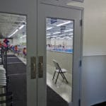 Glass doors into agility ring at Fusion Pet Retreat, Minnetonka MN