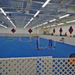 Agility Ring with jumps and half-solid wall on right at Fusion Pet Retreat, Minnetonka MN
