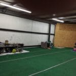 Dog crates indoors against facility walls with fans Pawsitive Partners, Indianapolis IN