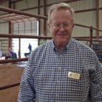 Trial judge Karl Johnson standing beside the trial ring at South St. Louis County Fairgrounds, Dirt Floor Arena, Proctor MN