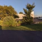 RVs on the side of 2 parking lots with grass and trees in-between the lots. At Pawsitive Partners, Indianapolis IN