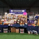 Dog and people Massage sign over vendor table with treats, massage oils, and more at Yellow Breeches Sports Center, New Cumberland PA