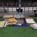 Vareity of dog beds arranged on the turf for sale Yellow Breeches Sports Center, New Cumberland PA