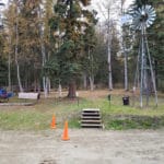 Grassy area next to windmill and forest for dog potty Camp Li-Wa, Fairbanks AK