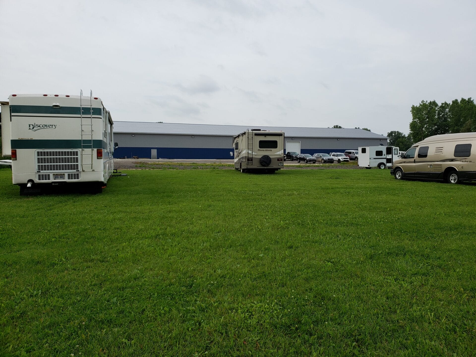 three RVs and a trailer parked on grass in front of All Dogs Can, Lapeer MI