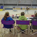 Timer, scribe, and assistant scribe sitting in folding chairs viewing the trial National Equestrian Center, Lake St Louis MO