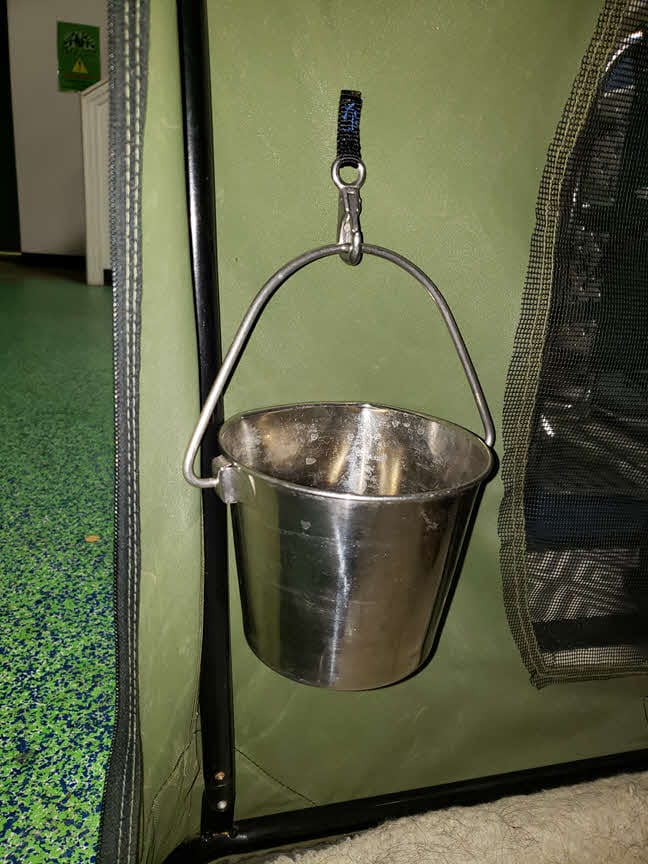 dog water bucket attached to strap on soft crate