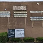 business name signs on a brick building for industrial park at forest city dog training club in love's park il